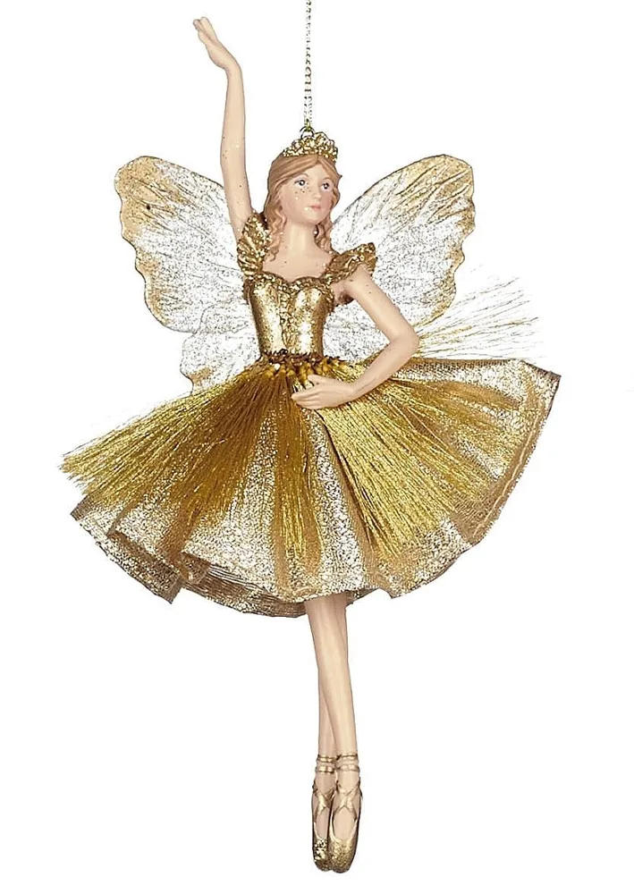 Zauberhafte Fee goldenem Kleidchen / ein Arm nach oben